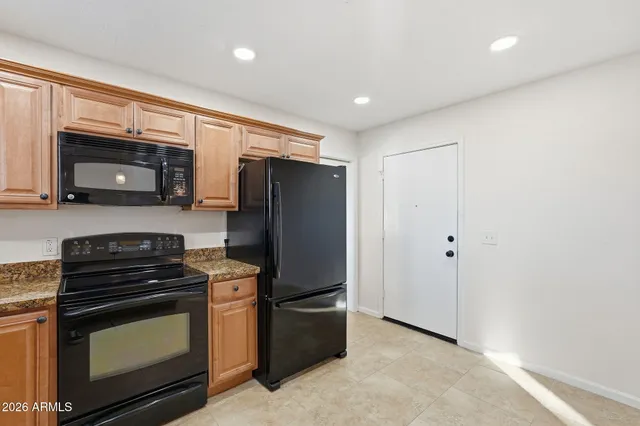 a kitchen with stainless steel appliances a refrigerator stove and microwave