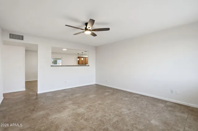 an empty room with a empty space and a ceiling fan