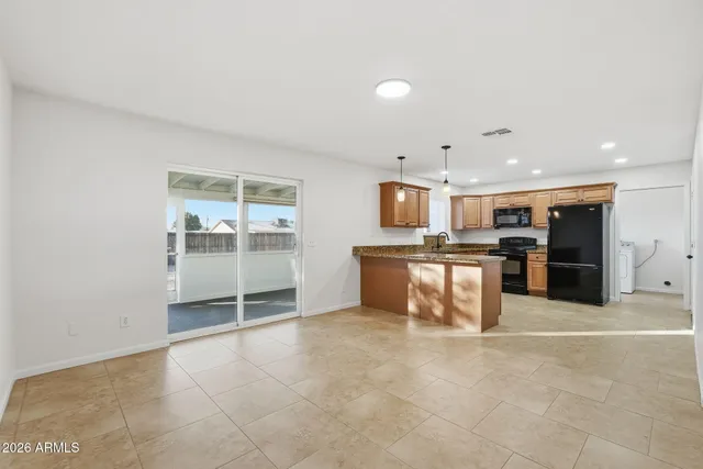 a view of kitchen with stainless steel appliances cabinets