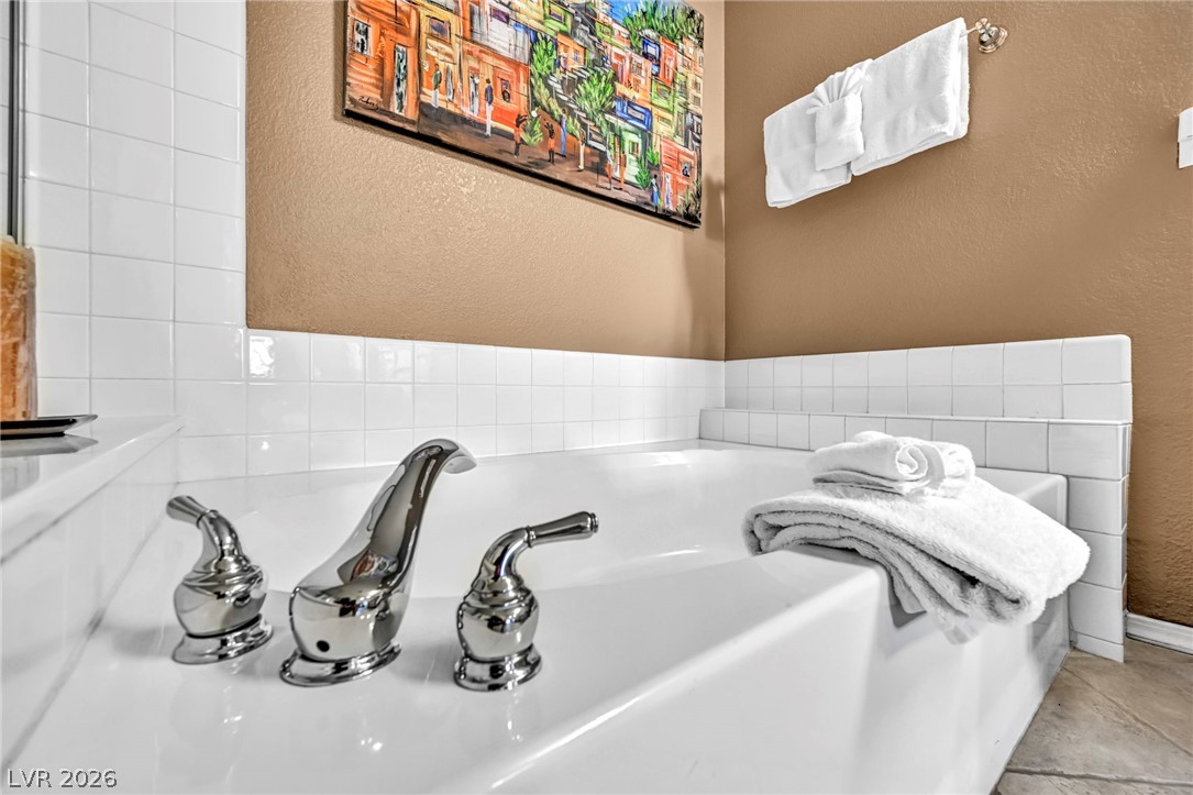 10730 Amber Ridge Drive, Unit 101 Las Vegas, NV 89144 - Photo 25 of 32 Indulge in relaxation with this inviting soaking tub, complete with sleek chrome fixtures.