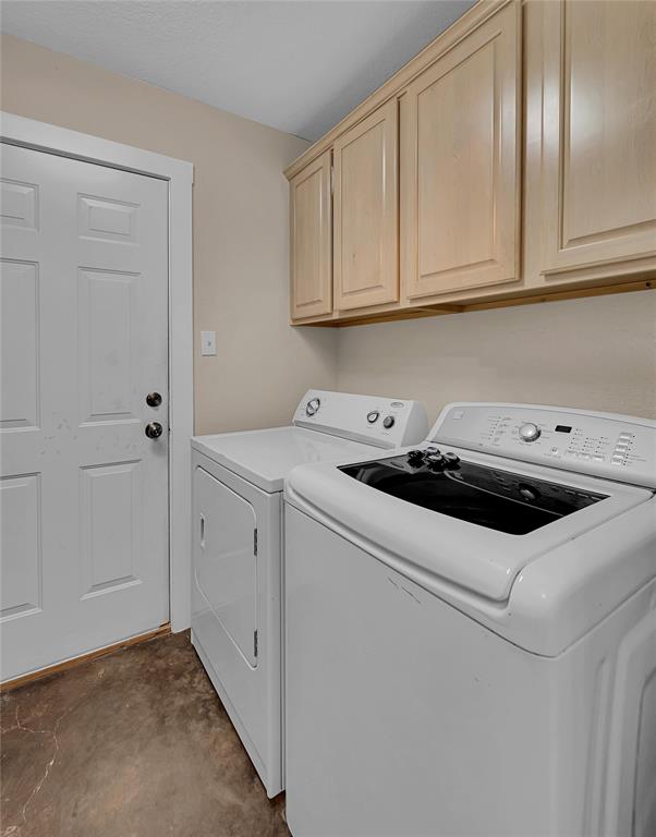 37 Bluebonnet Loop Morgan's Point Resort, TX 76513 - Photo 28 of 38 Laundry area featuring overhead cabinetry with light wood-finish doors, durable flooring, and a white paneled door with dark hardware