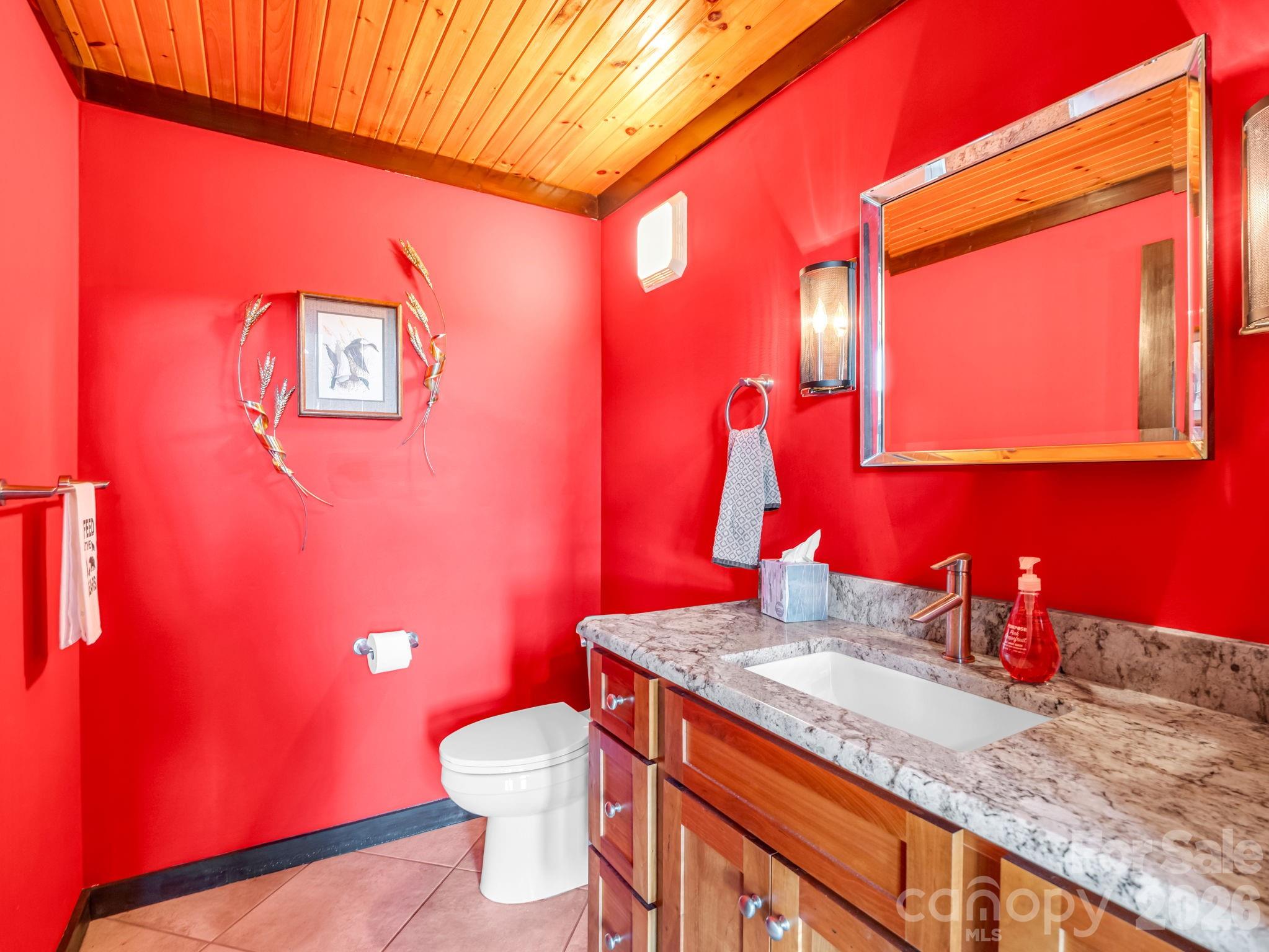 590 Boulder Ridge Lake Lure, NC 28746 - Photo 27 of 48 a bathroom with a granite countertop sink and a mirror