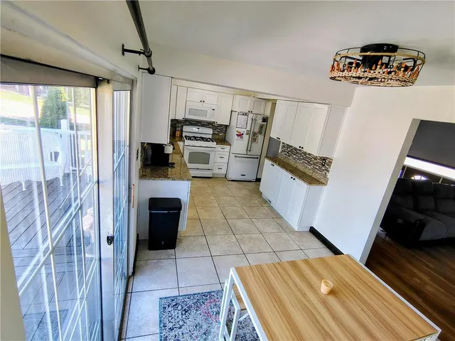 a kitchen with a refrigerator and a stove