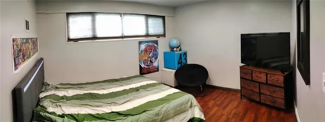 a bedroom with a bed and a workspace