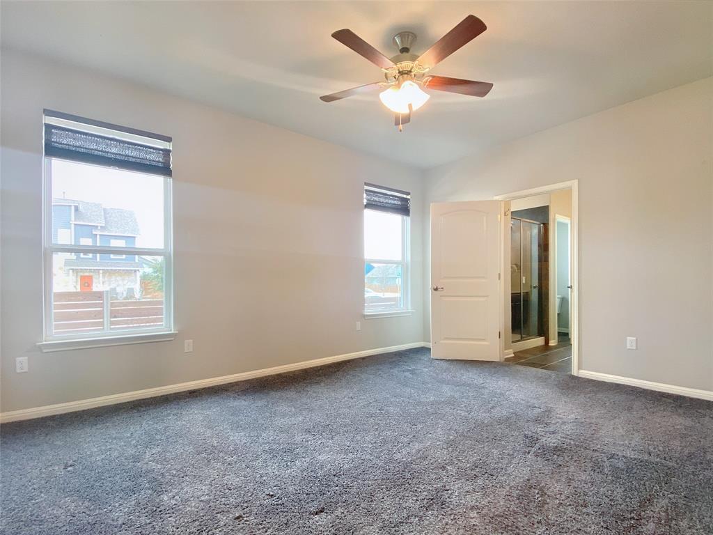 8901 Panhandle Drive Austin, TX 78747 - Photo 11 of 21 Spacious room featuring neutral-toned walls, plush grey carpeting, and dual windows with privacy blinds