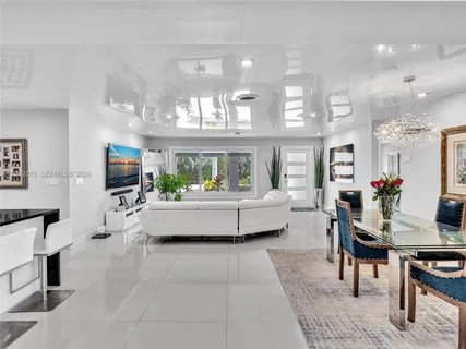 a kitchen with white cabinets and refrigerator