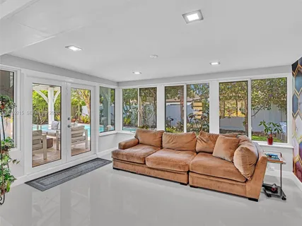a front view of a house with swimming pool having outdoor seating