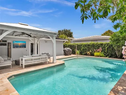 a bedroom with a large bed and a painting on the wall