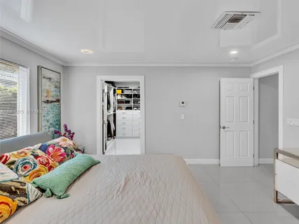 an aerial view of ocean and residential houses with outdoor space