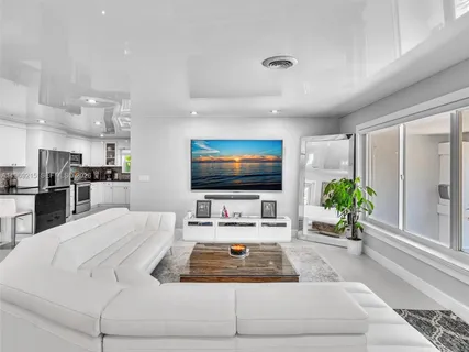 a view of a dining room with furniture and a chandelier