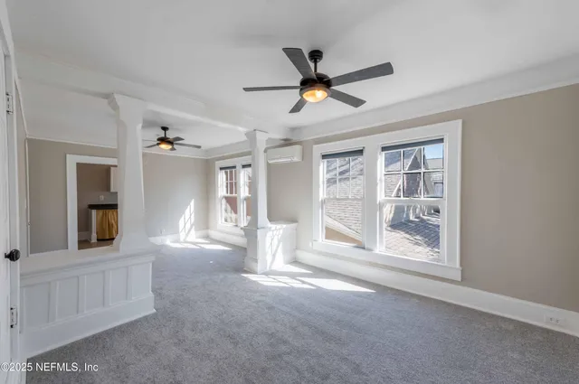 a view of a livingroom with a ceiling fan and window