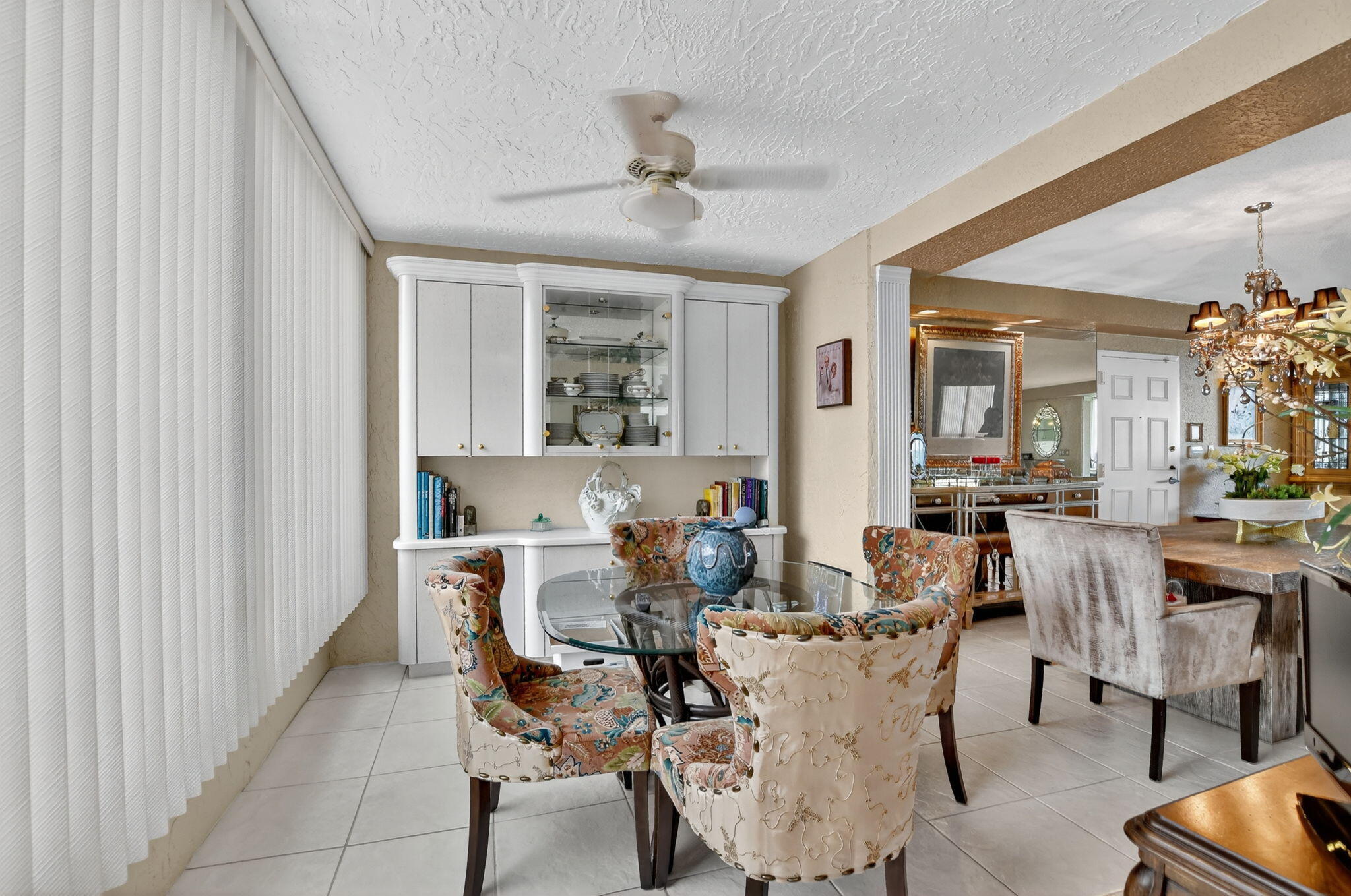 7178 Promenade Drive, Unit 502 Boca Raton, FL 33433 - Photo 12 of 33 a view of a dining room with furniture and a chandelier