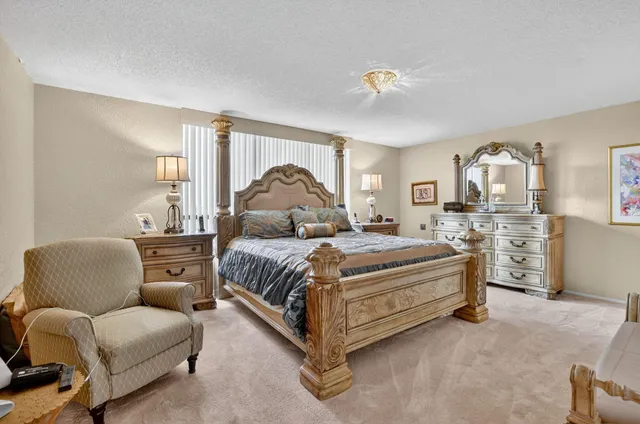 a bedroom with a bed a couch and dresser