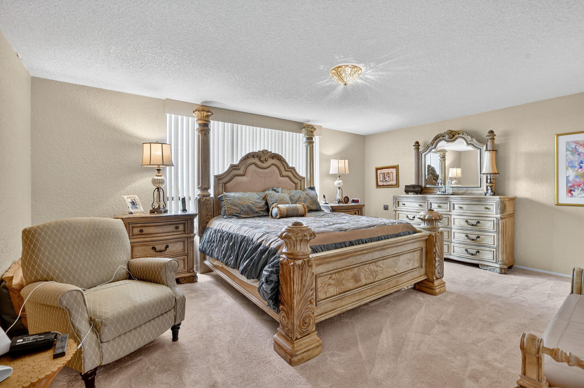 7178 Promenade Drive, Unit 502 Boca Raton, FL 33433 - Photo 17 of 33 a bedroom with a bed a couch and dresser