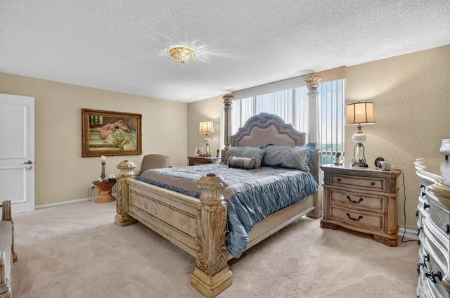 a bedroom with a bed dresser and window