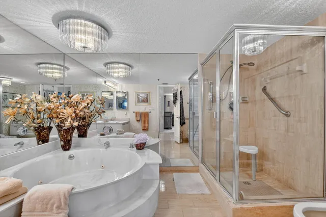 a bathroom with a bathtub a shower and a sink