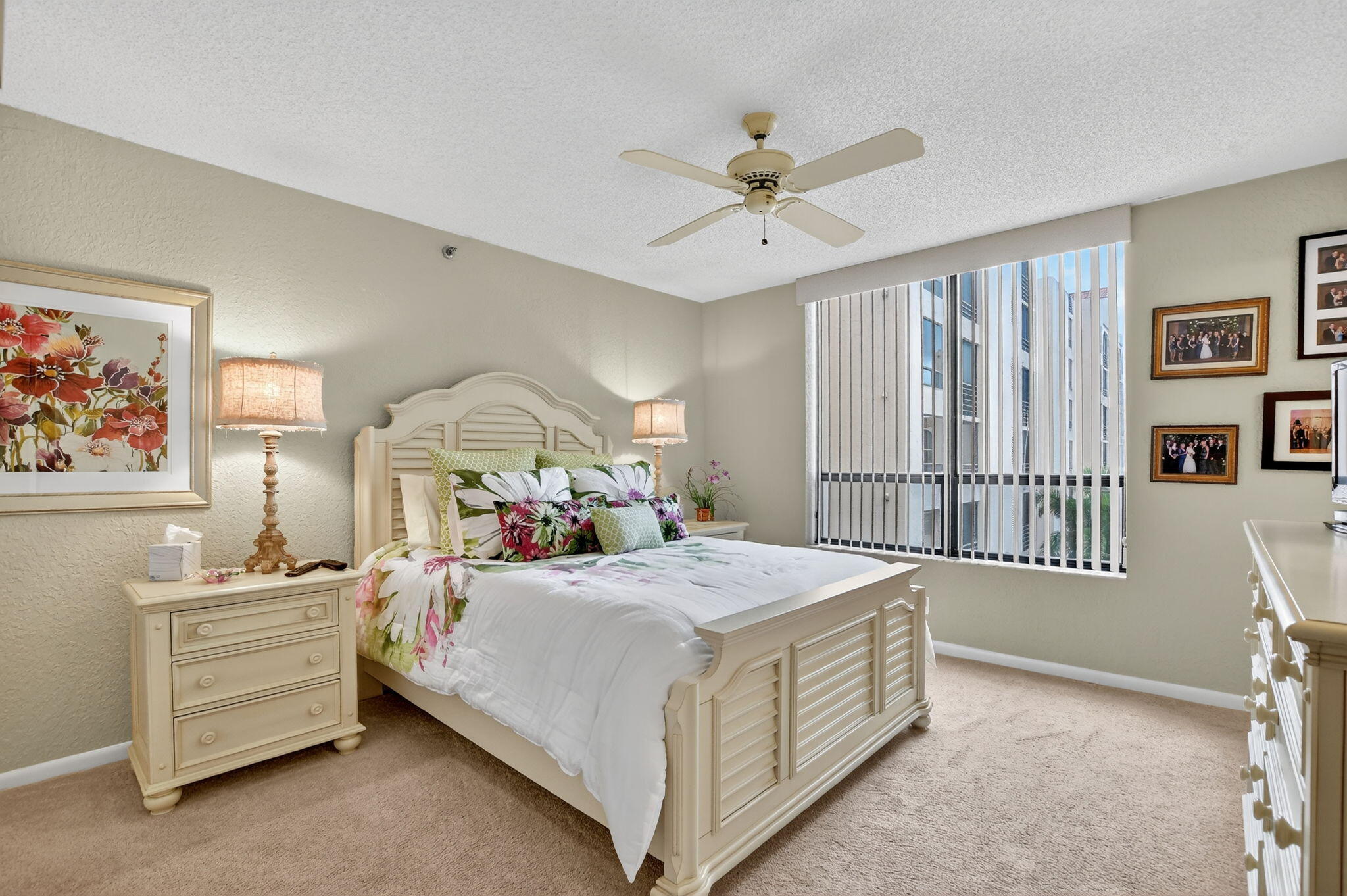 7178 Promenade Drive, Unit 502 Boca Raton, FL 33433 - Photo 24 of 33 a bedroom with a bed and a chandelier