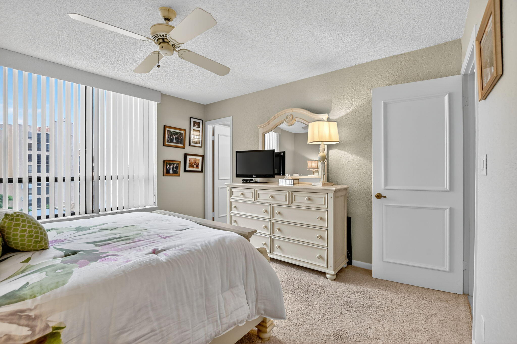 7178 Promenade Drive, Unit 502 Boca Raton, FL 33433 - Photo 25 of 33 a bed room with a bed a television and dresser