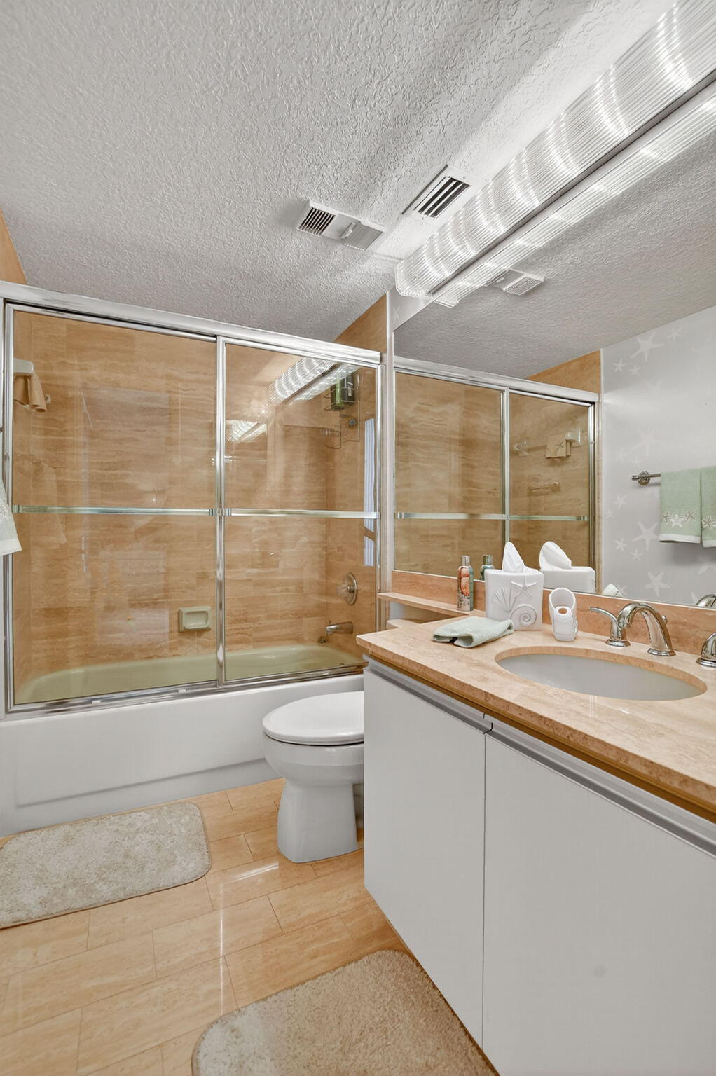 7178 Promenade Drive, Unit 502 Boca Raton, FL 33433 - Photo 28 of 33 a bathroom with a granite countertop sink a toilet and shower