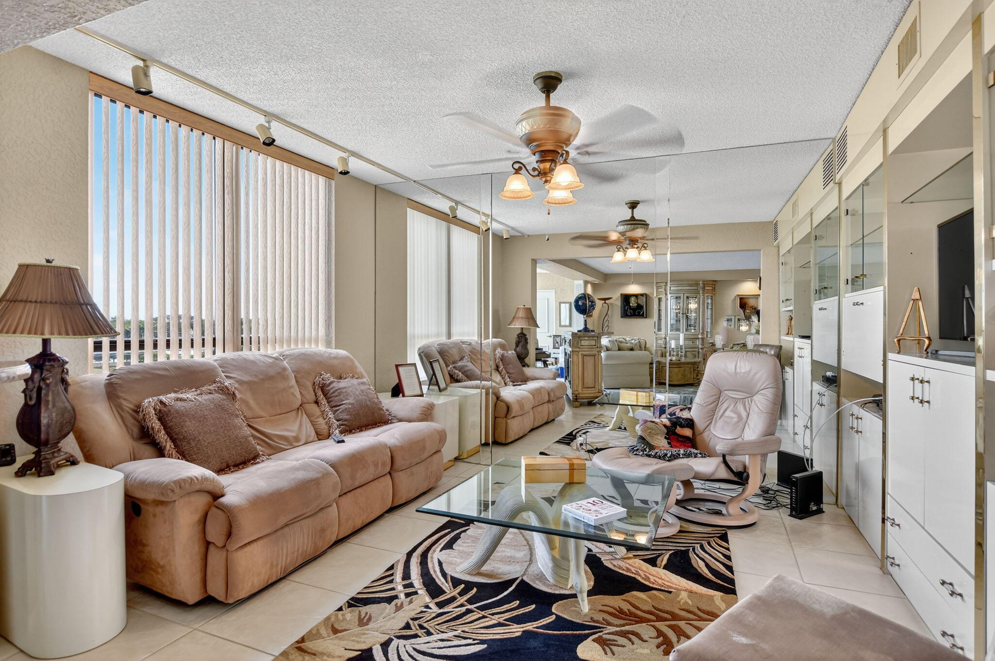 7178 Promenade Drive, Unit 502 Boca Raton, FL 33433 - Photo 9 of 33 a living room with furniture ceiling fan and a rug