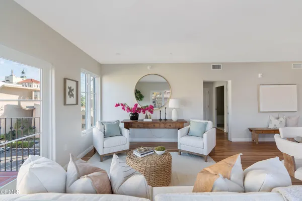 a living room with furniture and a potted plant