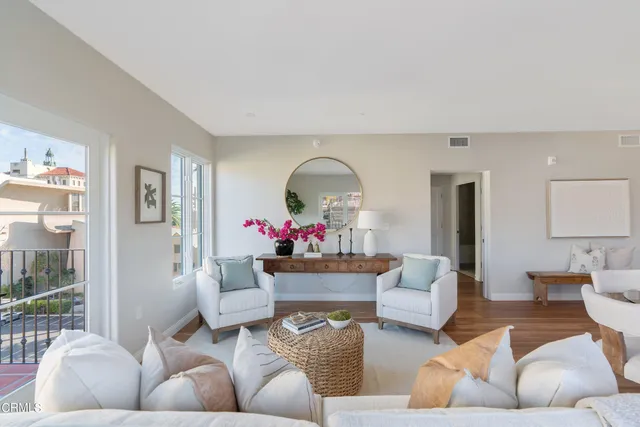 a living room with furniture and a potted plant