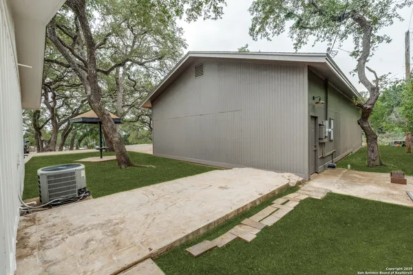 a view of backyard with outdoor seating and stairs
