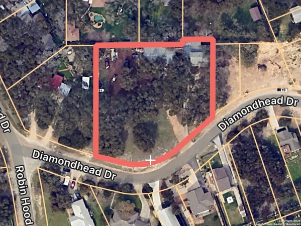 a view of an empty room with a fireplace and window