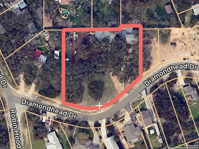 a view of an empty room with a fireplace and window