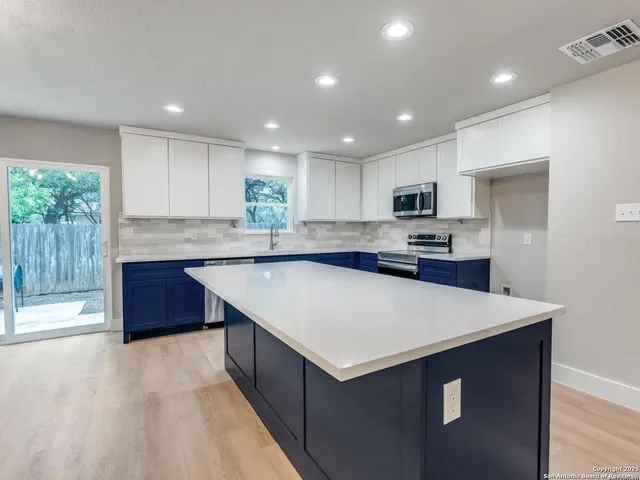 a room with a large bed and a chandelier