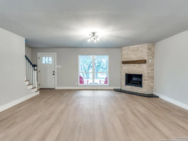 an empty room with a empty space and windows