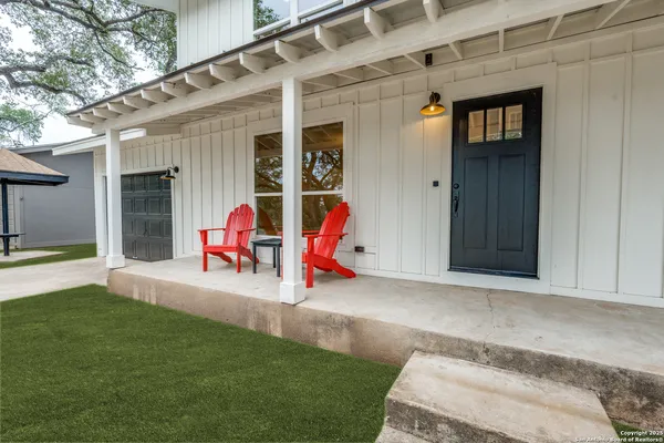 a view of a house with a backyard and porch