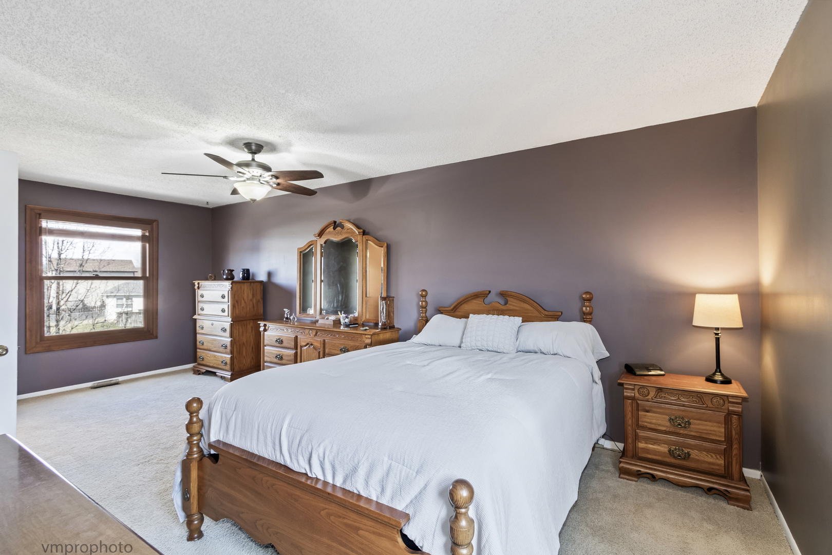 832 Kansas Street Carol Stream, IL 60188 - Photo 10 of 26 a bedroom with a bed and a chandelier