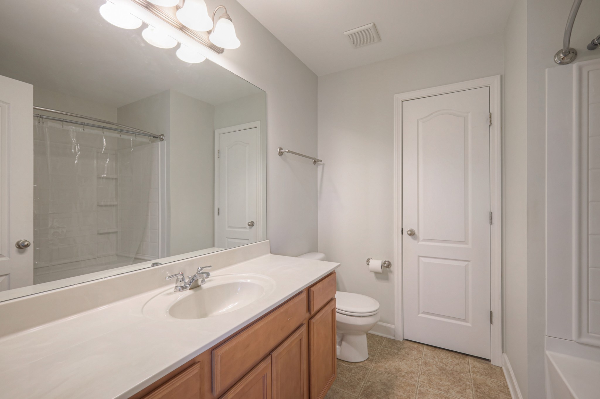 5441 Perlou Lane Murfreesboro, TN 37128 - Photo 19 of 29 a bathroom with a granite countertop sink toilet a large mirror a shower and a bathtub