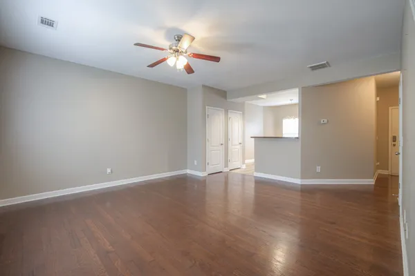 a view of an empty room with wooden floor