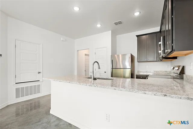 a bathroom with granite countertop a sink and a mirror