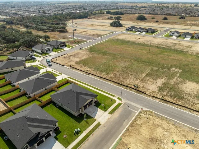 a view of a house with a wooden fence