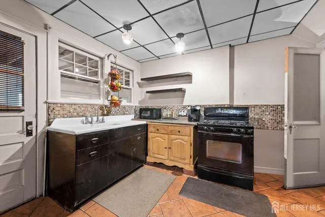 a kitchen with a stove sink and refrigerator