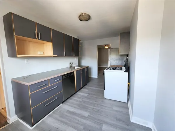 a kitchen with stainless steel appliances a stove microwave and cabinets