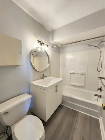 a bathroom with a sink mirror vanity and toilet