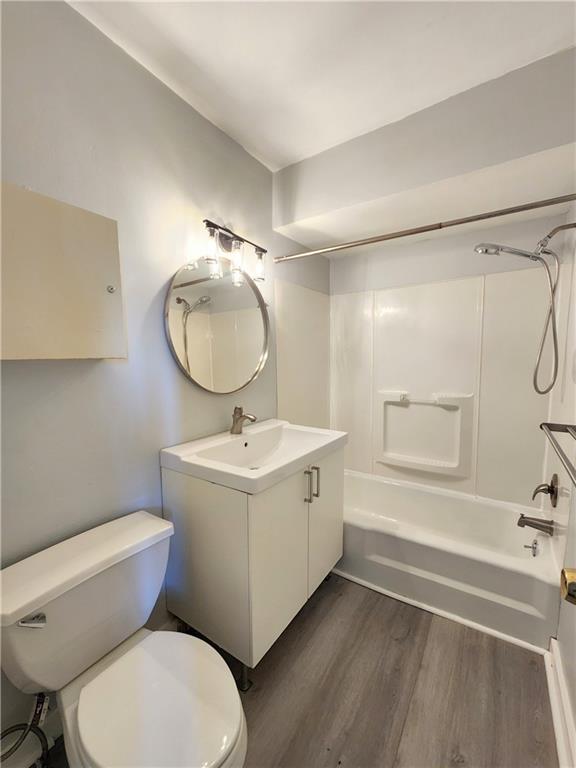 5237 Butler Street, Unit 2 Pittsburgh, PA 15201 - Photo 4 of 6 a bathroom with a sink mirror vanity and toilet