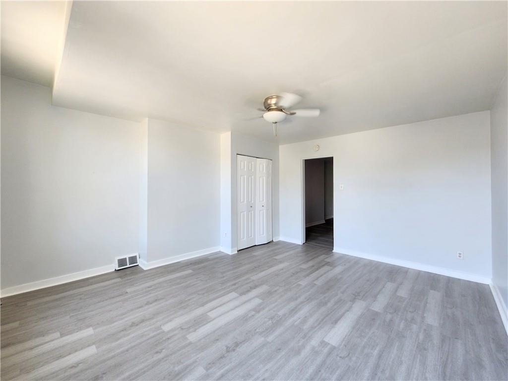 5237 Butler Street, Unit 2 Pittsburgh, PA 15201 - Photo 5 of 6 a view of an empty room with wooden floor