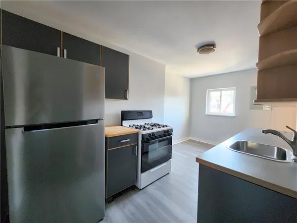 a kitchen with a refrigerator and a sink