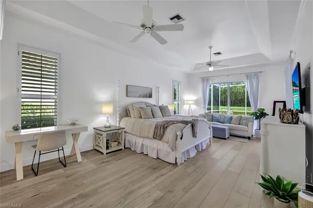 a spacious bedroom with a bed and a large window