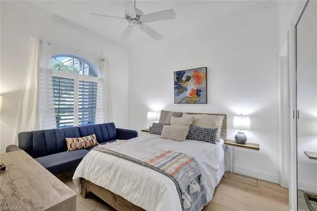 a bedroom with bed and a large window