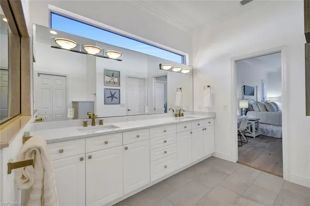 a spacious bathroom with double sink and a mirror