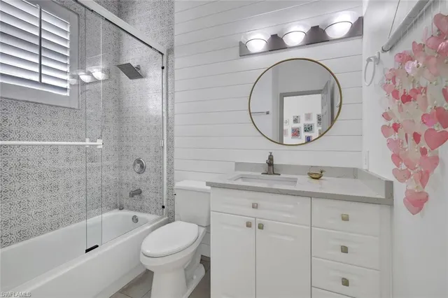 a bathroom with a toilet a sink and a mirror