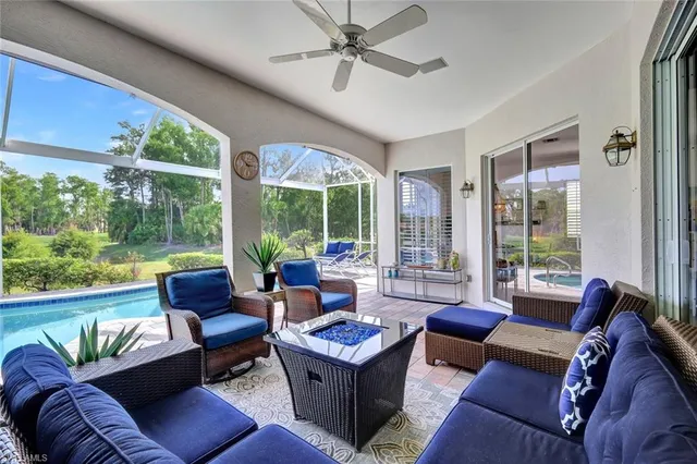 a living room with furniture and a floor to ceiling window