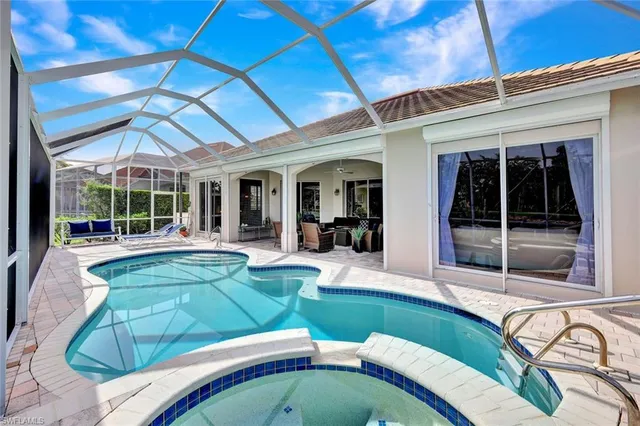 a view of a house with swimming pool and porch with furniture