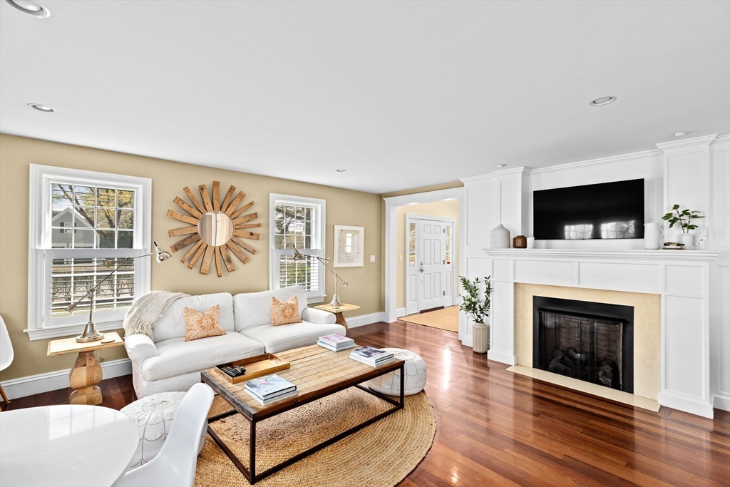 50 Pleasant Street Hingham, MA 02043 - Photo 11 of 41 a living room with furniture a fireplace and a flat screen tv